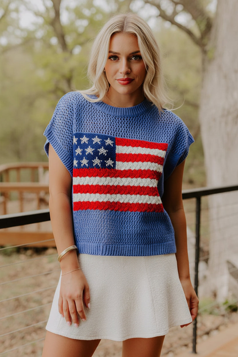 Woman wearing a blue sweater with an American flag design.