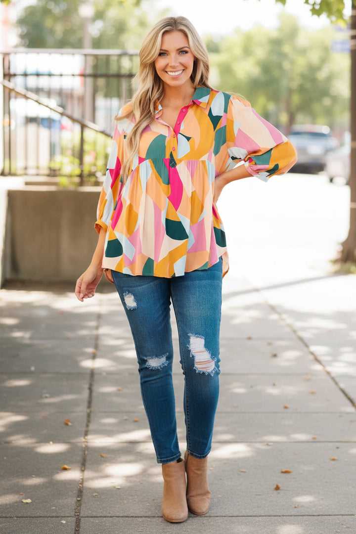 Woman wearing a colorful patterned blouse with a blurred outdoor background