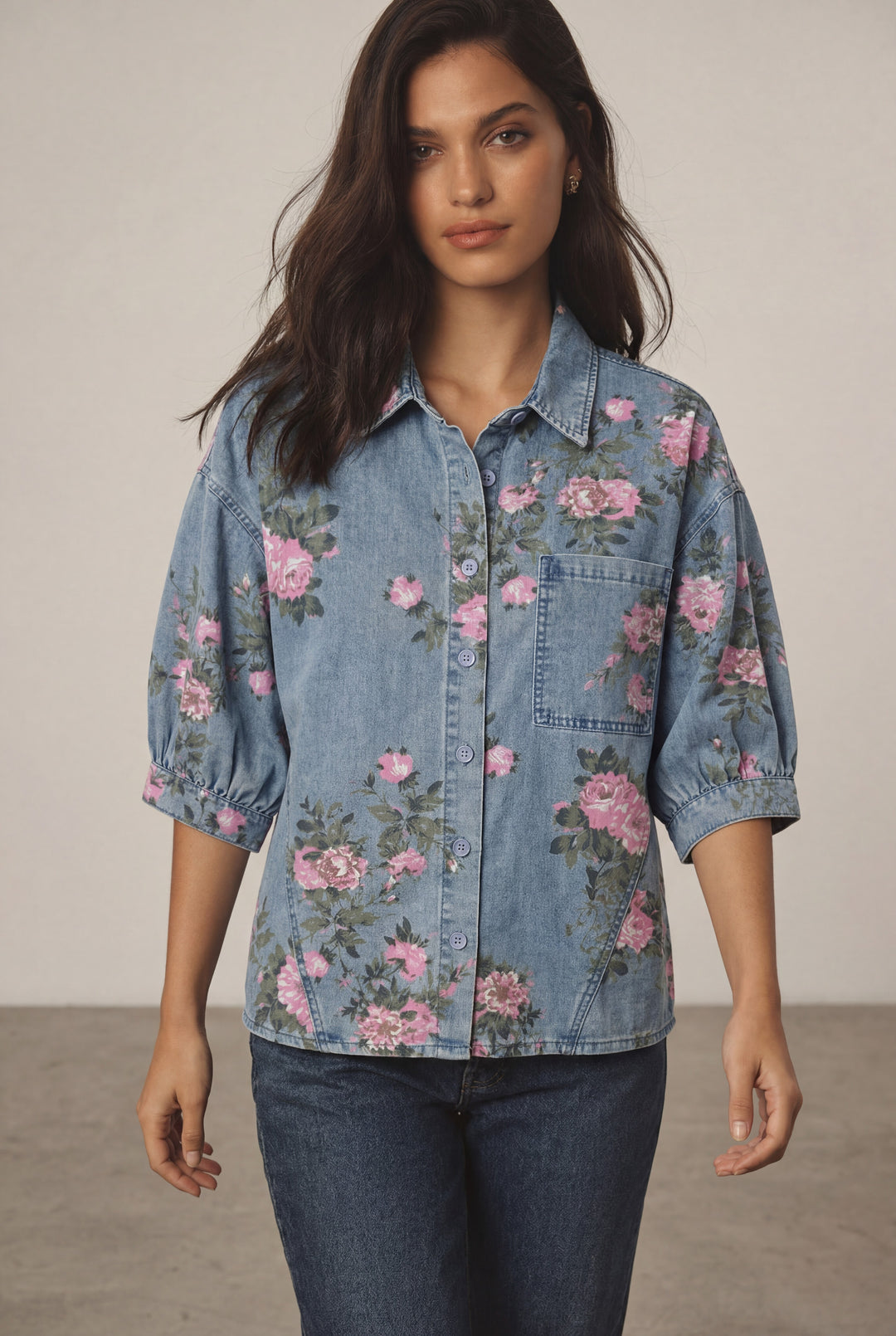 Errabelly blue denim shirt with pink floral print and bracelet-length puff sleeves. Features a chest pocket and button-up front.