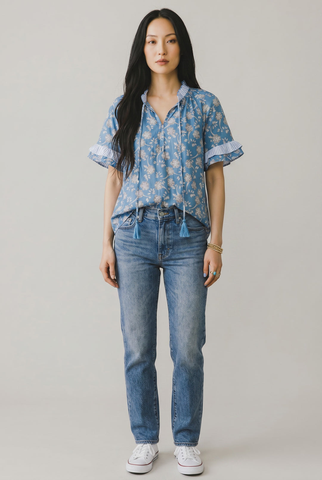 Errabelly blue floral print short sleeve blouse with striped ruffle trim and tie detail.