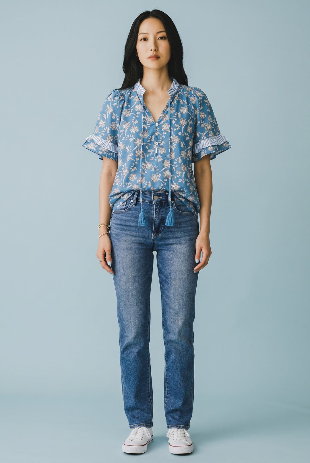 Errabelly blue floral print short sleeve blouse with striped trim, tie neck, and button details.