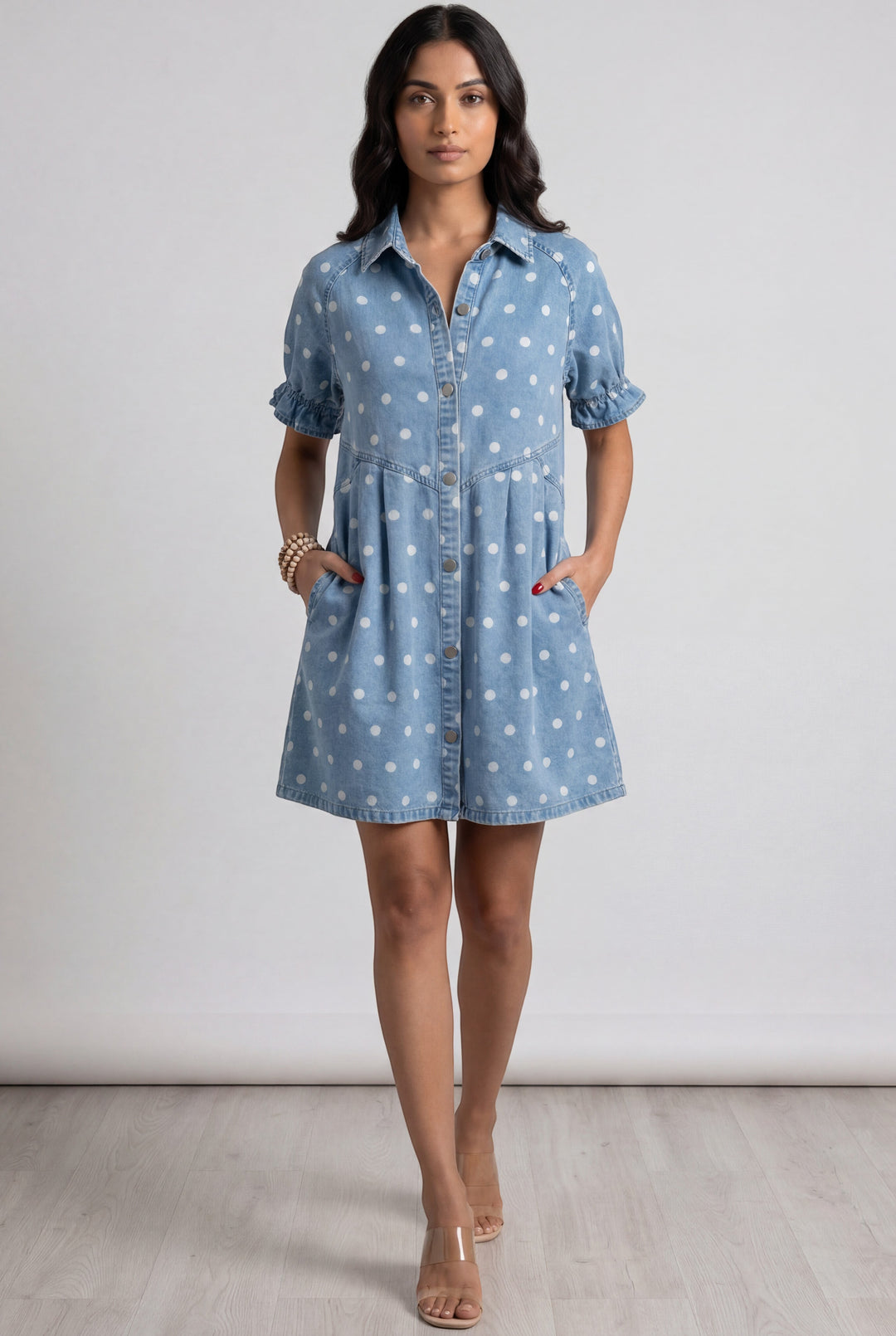 Errabelly light blue denim dress with white polka dots, short puff sleeves, and button-down front.