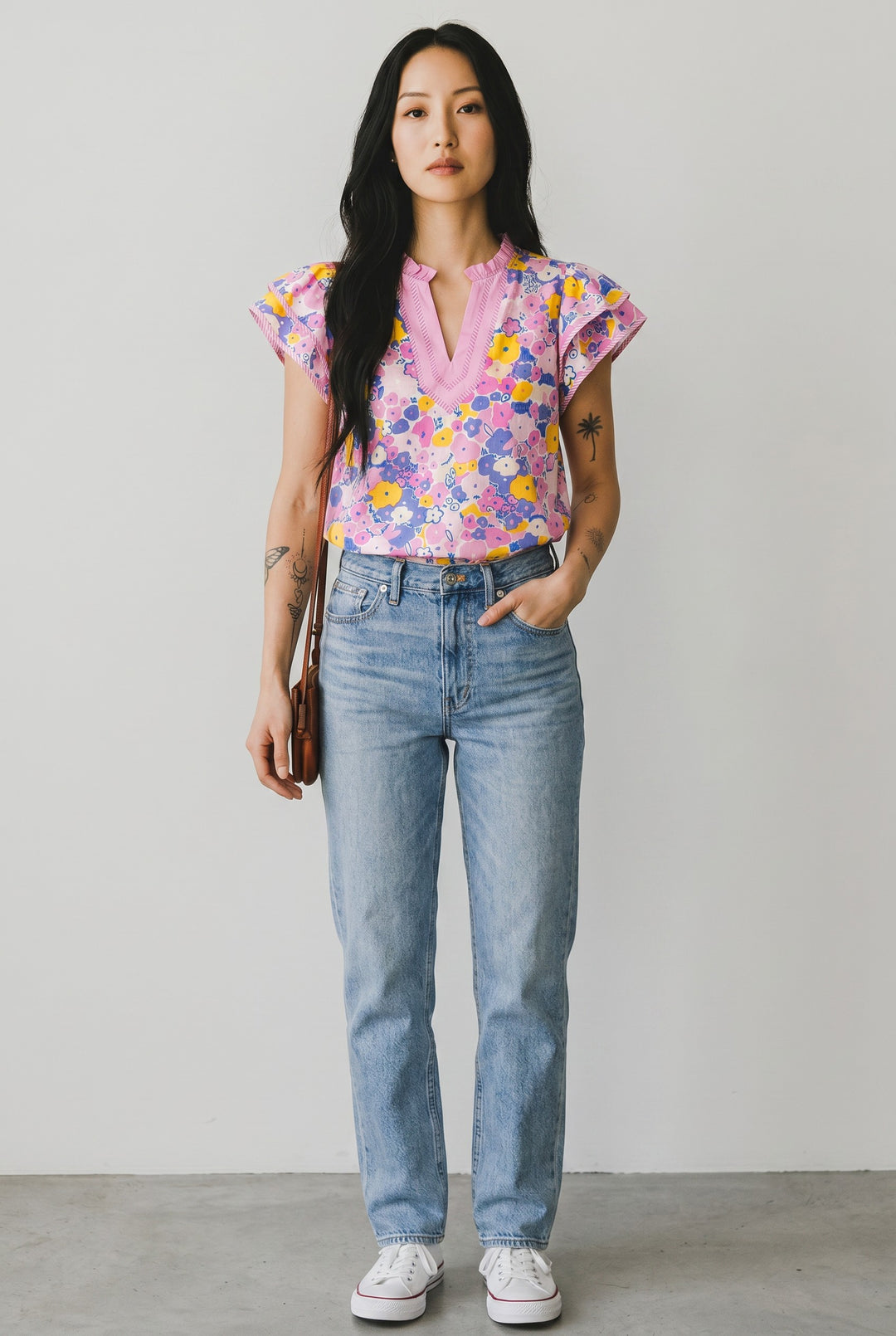 Errabelly pink, yellow, and blue floral print blouse with pink trim, V-neck, and flutter sleeves. Cotton-viscose blend.