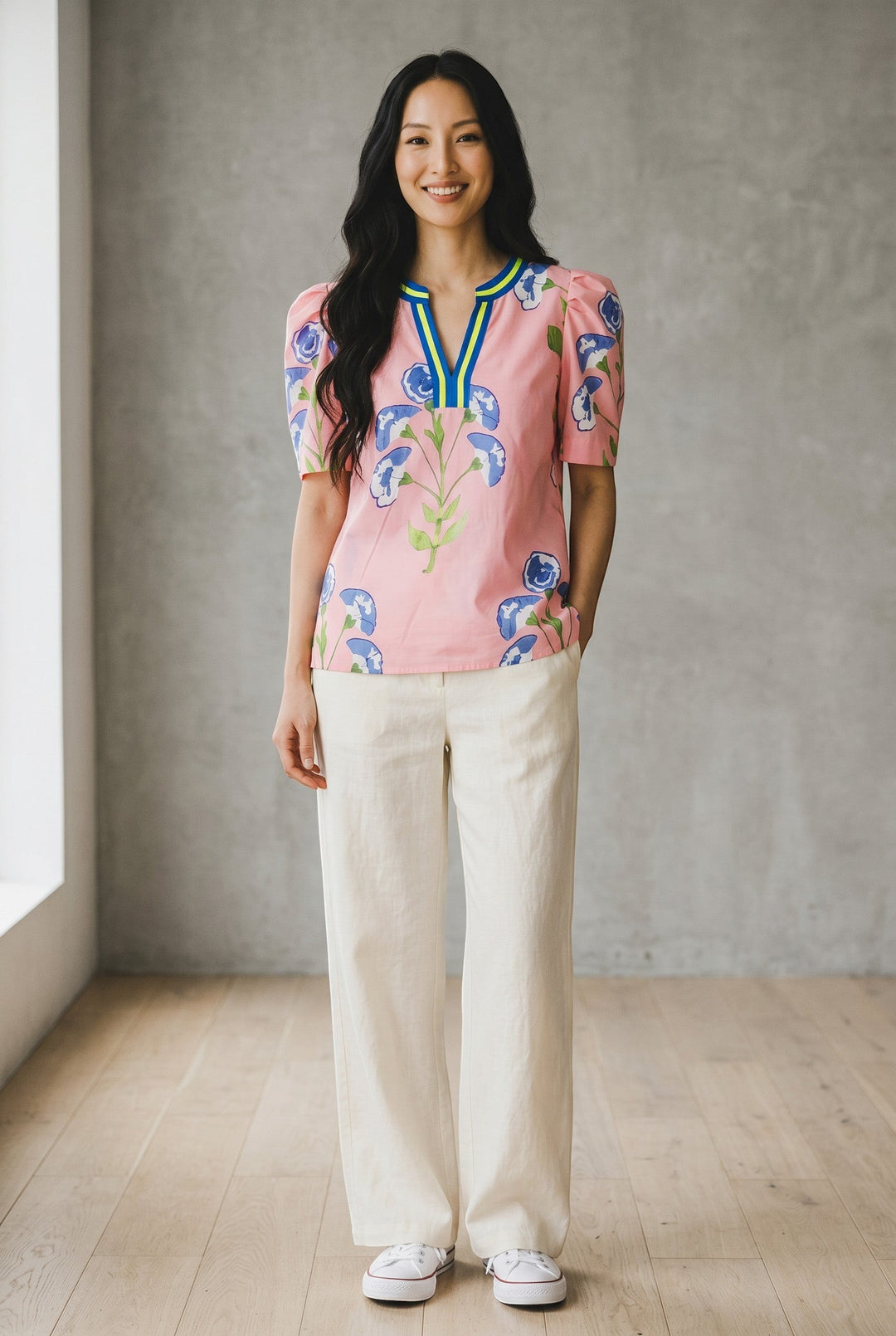 Errabelly pink blouse with blue floral print, notched V-neck, and bubble sleeves. Lightweight fabric for comfortable wear.