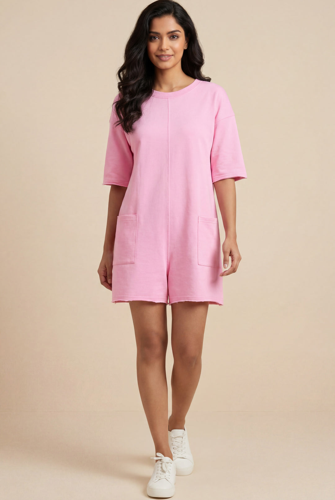 Errabelly pink solid color raw edge half sleeve pocketed loose romper with crew neck and two front pockets.